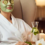 Spa day at home: Woman enjoying relaxation with face mask, candles, and spa essentials.