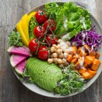 Fresh organic vibrant green smoothie bowl packed with dark leafy crucifers